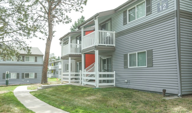 Enjoy a walk on our beautiful grounds Apartment building exterior with sidewalk
