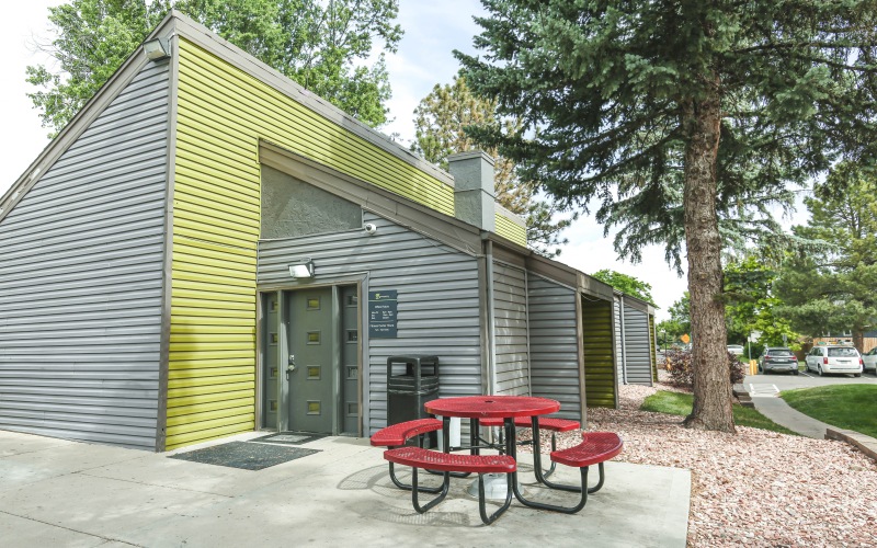 Apartment building exterior with red picnic table