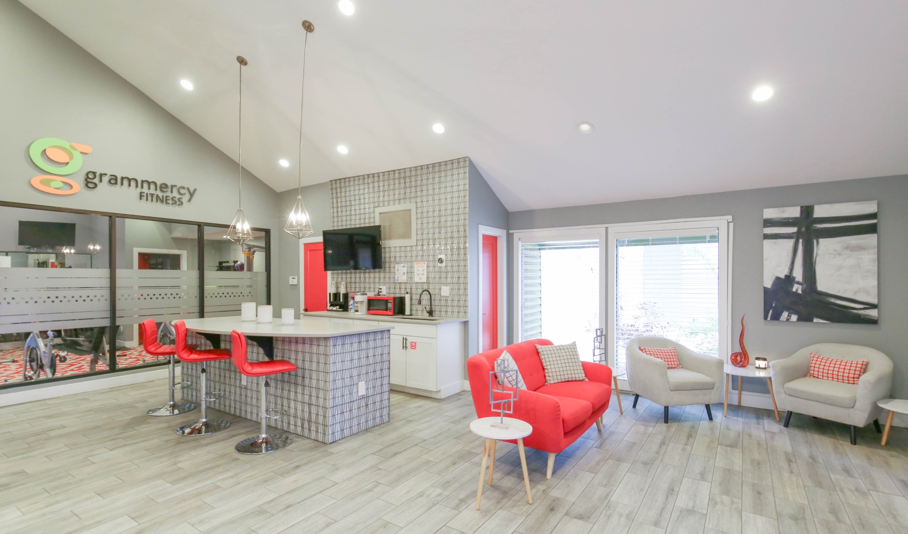 Grab coffee in our resident clubhouse Apartment leasing office with kitchen and pink furniture